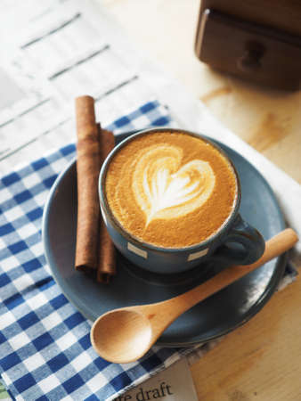 cup of coffee on the wood desk with business newspaper in vintage color tonedの写真素材