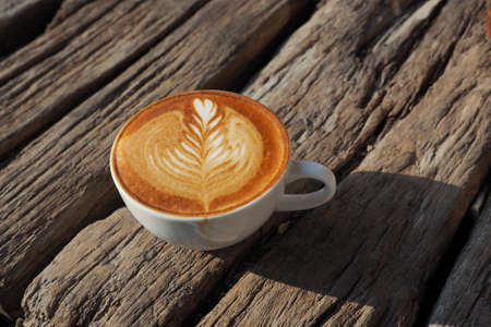 cup of coffee latte art on the wood background in vintage color styleの写真素材
