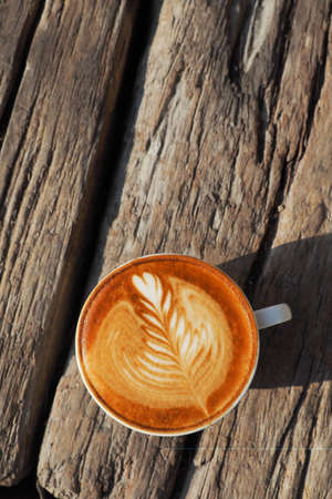 cup of coffee latte art on the wood background in vintage color styleの写真素材