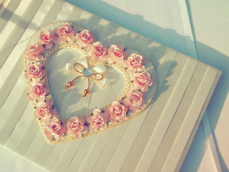 pink rose on the wedding book in wedding day vintage color toneの写真素材