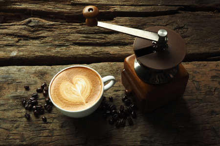 cup of coffee latte art on the wood background low key vintage color toneの写真素材