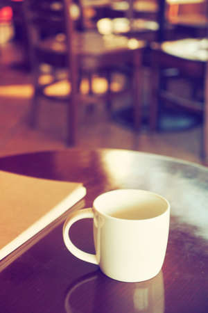 vintage color tone of  cup of coffee  on the table coffee shopの写真素材