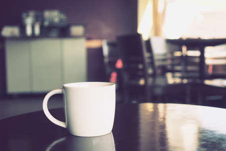 vintage color tone of  cup of coffee  on the table coffee shopの写真素材