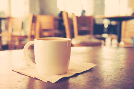 vintage color tone of  cup of coffee  on the table coffee shopの写真素材