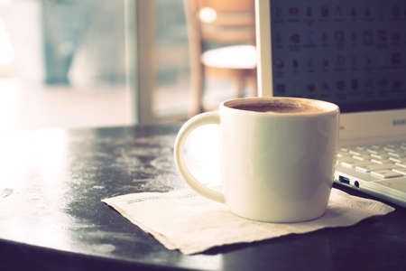vintage color tone of  cup of coffee  on the table coffee shopの写真素材