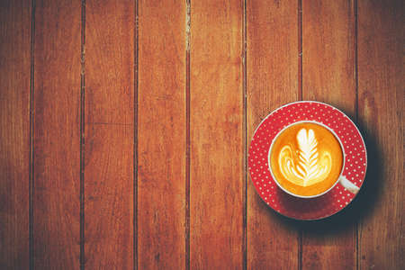 cup of coffee latte art on the wooden deskの写真素材