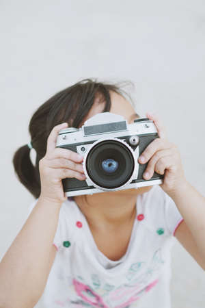 vintage camera with little girl in vintage color toneの写真素材