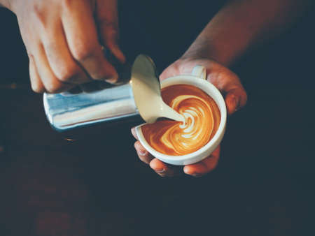 vintage color tone of  cup of coffee latte artの写真素材