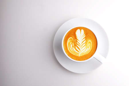 cup of coffee latte art top view on white backgroundの写真素材