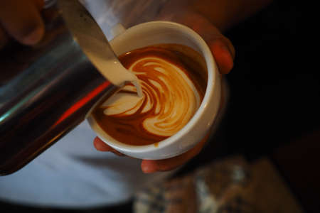 cup of coffee latte art on the wood background in vintage color styleの写真素材