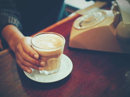 cup of coffee latte art on the wooden deskの写真素材