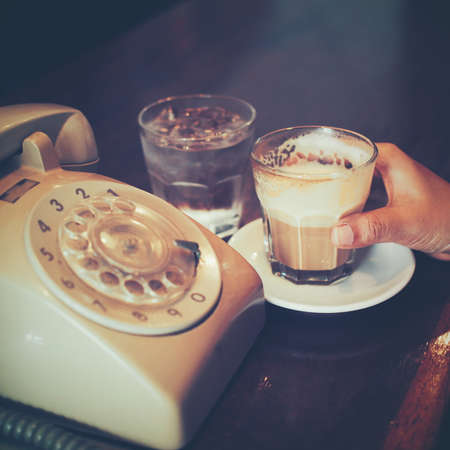 cup of coffee latte art on the wooden deskの写真素材