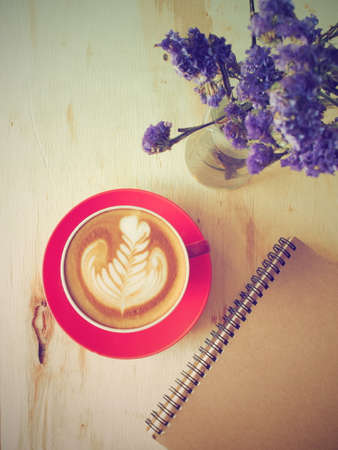 cup of coffee latte art on the wooden deskの写真素材