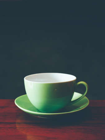cup of coffee latte art on the wooden deskの写真素材