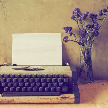vintage typewriter on the wood texture background with vintage color toneの写真素材