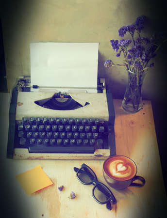 vintage typewriter on the wood texture background with vintage color toneの写真素材