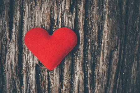 red heart on the wood texture vintage color toneの写真素材
