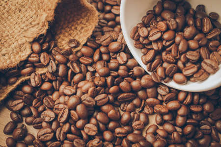 coffee beans on the wood texture vintage color toneの写真素材