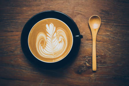 coffee latte art on the wood desk vintage colorの写真素材