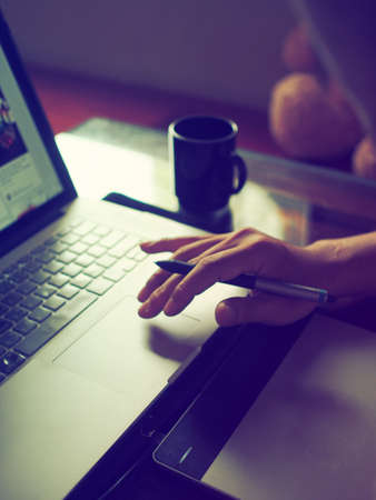 close up hands multitasking man using laptop connecting wifiの写真素材