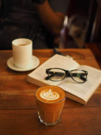 cup of coffee latte art on the wood desk in vintage color toneの写真素材