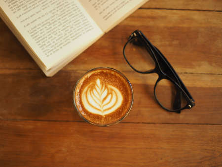 cup of coffee latte art on the wood desk in vintage color toneの写真素材