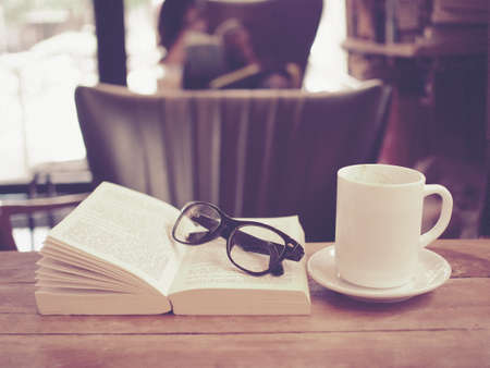 cup of coffee latte art on the wood desk in vintage color toneの写真素材