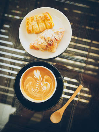 cup of coffee latte on the wood textureの写真素材