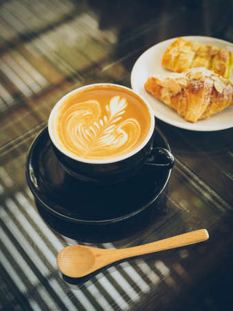 cup of coffee latte on the wood textureの写真素材