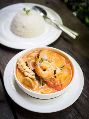 Thai food : Tom Yum sea food soup on the wood textureの写真素材