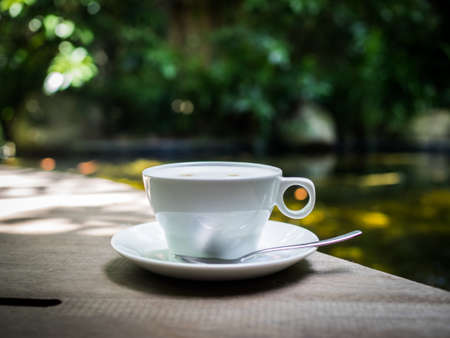 cup of coffee latte on the wood textureの写真素材