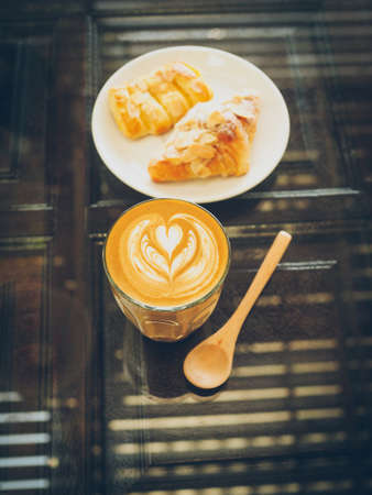 cup of coffee latte on the wood textureの写真素材