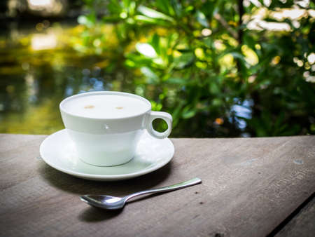 cup of coffee latte on the wood textureの写真素材