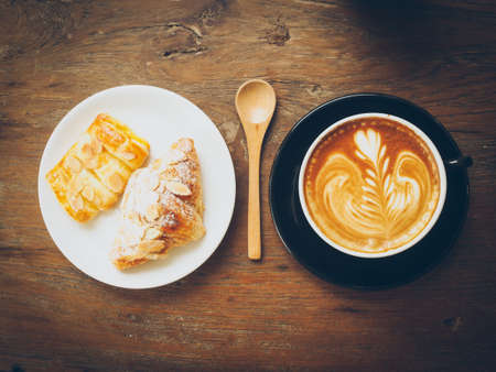cup of coffee latte on the wood textureの写真素材