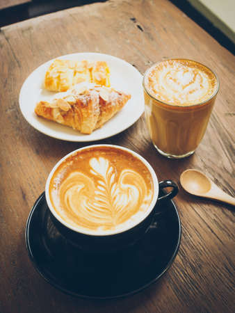 cup of coffee latte on the wood textureの写真素材