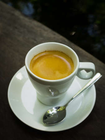 cup of coffee espresso on the wood deskの写真素材