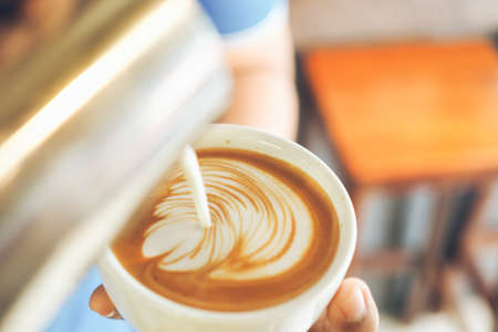 cup of coffee latte on the wood textureの写真素材