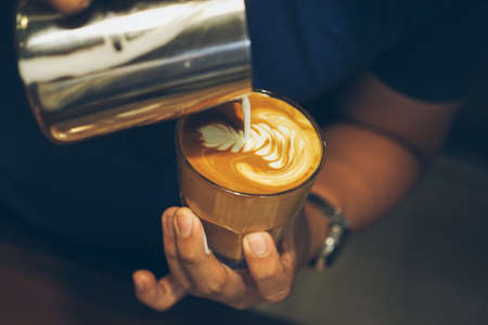 cup of coffee latte on the wood textureの写真素材