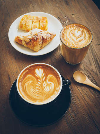 cup of coffee latte on the wood textureの写真素材
