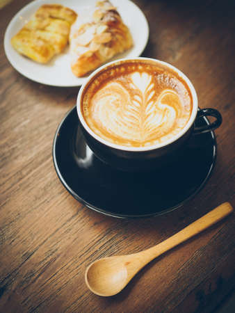 cup of coffee latte on the wood textureの写真素材