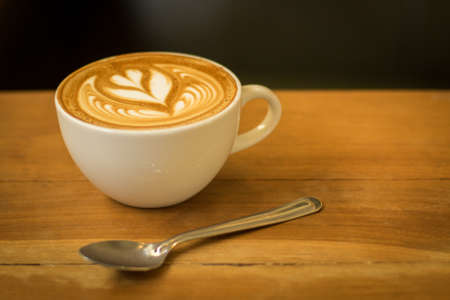 cup of coffee latte on the wood textureの写真素材