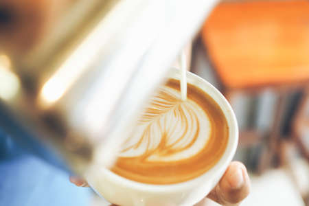 cup of coffee latte on the wood textureの写真素材