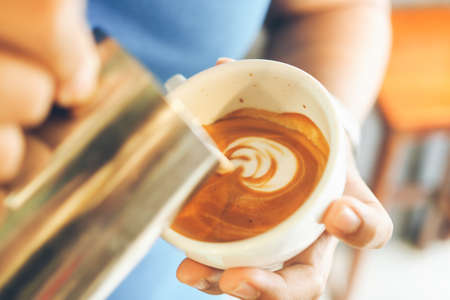 cup of coffee latte on the wood textureの写真素材
