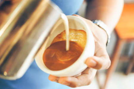 cup of coffee latte on the wood textureの写真素材