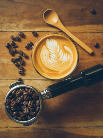 cup of coffee latte on the wood texture   in vintage color toneの写真素材