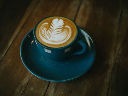 cup of coffee latte on the wood texture   in vintage color toneの写真素材