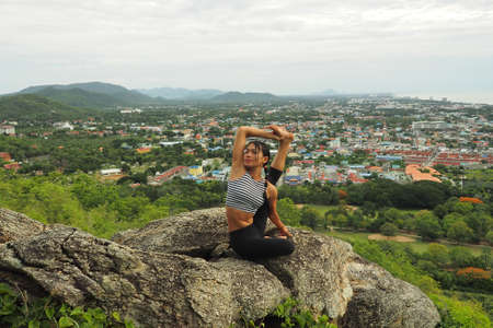 Young woman doing yoga exercises in the garden parkの写真素材