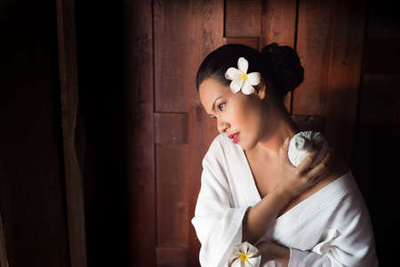 Masseur doing massage on Asian woman body in the spa salonの写真素材