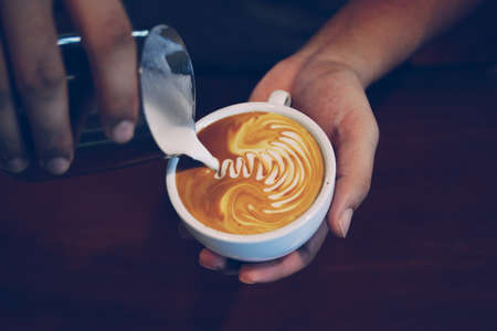vintage color tone of  cup of coffee latte artの写真素材