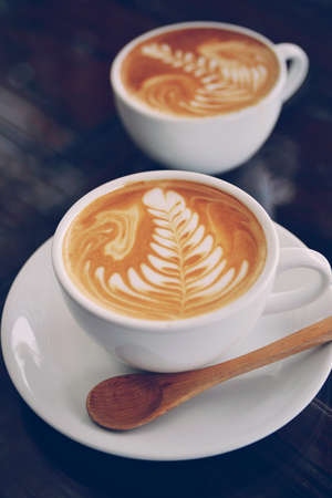 vintage color tone of  cup of coffee latte artの写真素材
